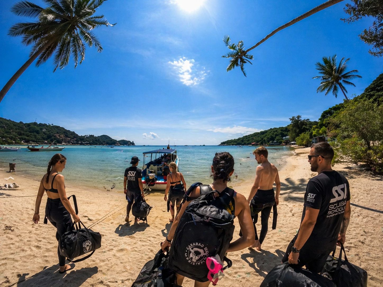Scuba divers exploring a reef on Koh Tao, heading out from Chalok Bay