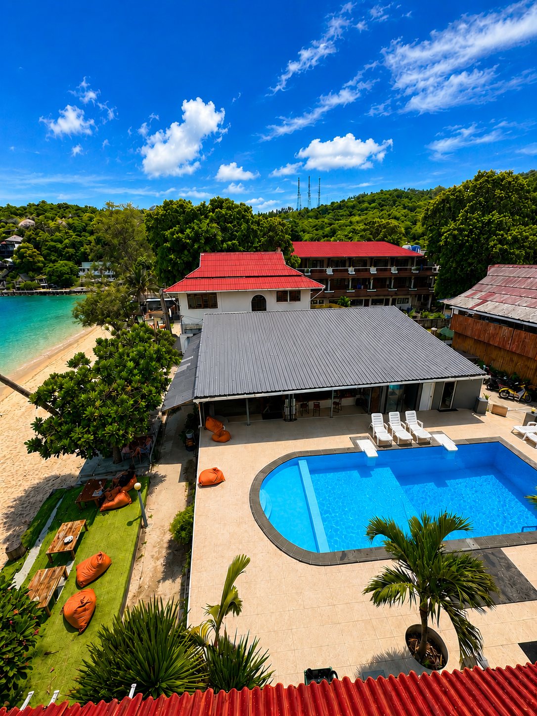 Aerial of Carabao Diving Resort showing the beachfront pool, restaurant and beach on Chalok Bay, Koh Tao